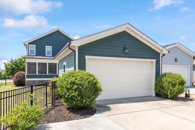 ranch-style house with fence, driveway, and a garage