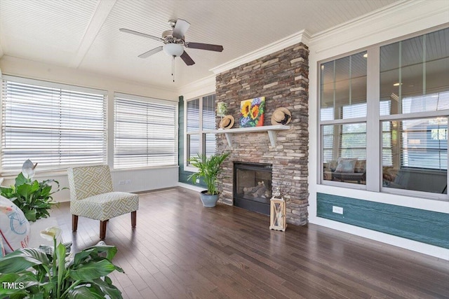 sitting room featuring a ceiling fan, baseboards, and a wealth of natural light