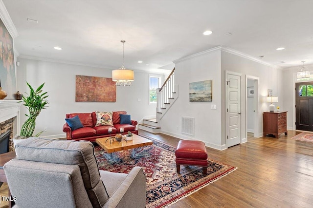 living area featuring recessed lighting, a notable chandelier, and wood finished floors