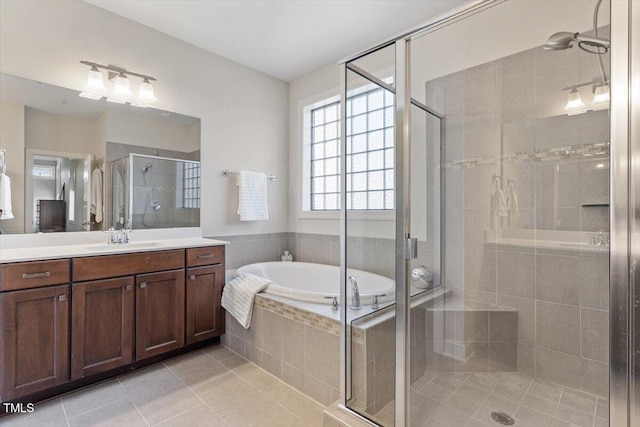full bath featuring vanity, tile patterned floors, a garden tub, and a stall shower