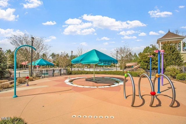 view of playground featuring fence