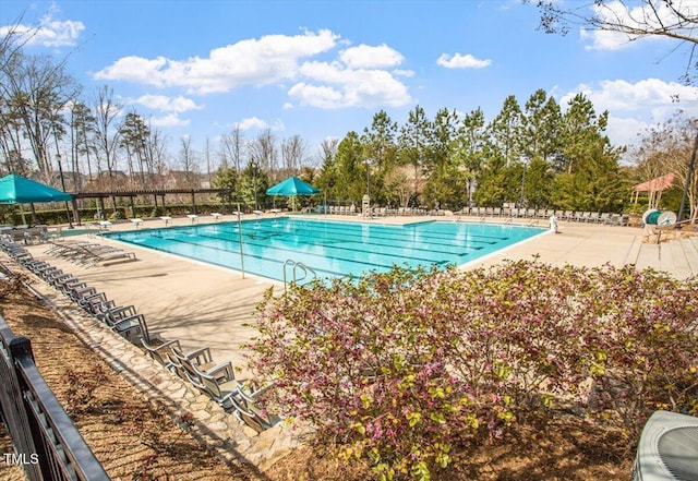 pool with a patio, fence, and cooling unit