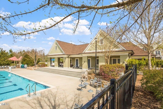 back of house featuring a patio, a community pool, fence, and brick siding