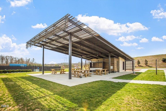 view of community featuring a yard and a pergola