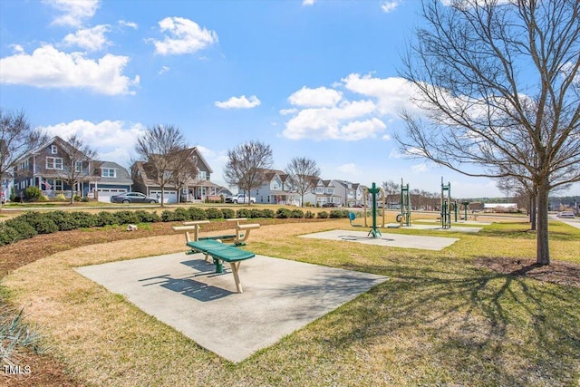 view of home's community featuring a lawn and a residential view