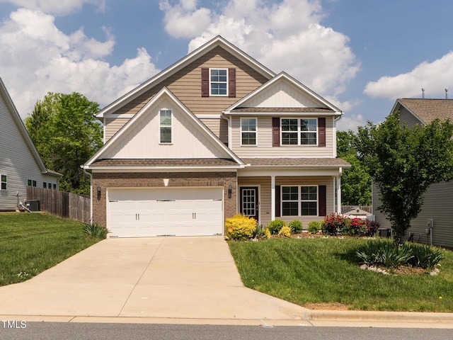 craftsman inspired home with an attached garage, concrete driveway, fence, and a front yard