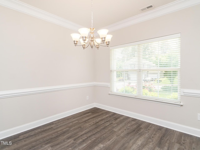 empty room with baseboards, ornamental molding, dark wood finished floors, visible vents, and a chandelier