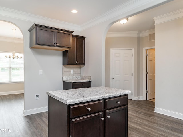 kitchen with arched walkways, dark wood-style flooring, baseboards, and dark brown cabinetry