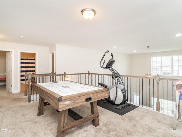 game room with baseboards and light carpet
