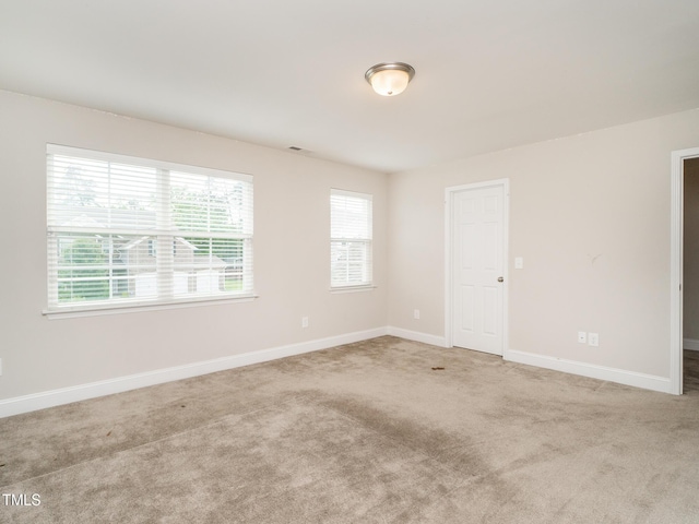 carpeted empty room with baseboards and visible vents