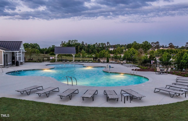 community pool featuring fence and a patio area