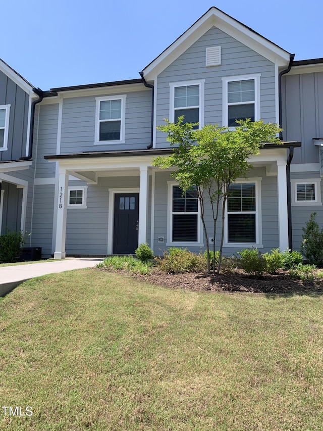 traditional home with board and batten siding and a front lawn