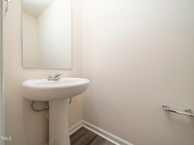 1218 S Franklin St, Wake Forest, NC 27587 - bathroom featuring baseboards and wood finished floors
