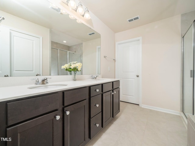 1218 S Franklin St, Wake Forest, NC 27587 - bathroom featuring a stall shower, double vanity, tile patterned floors, and baseboards
