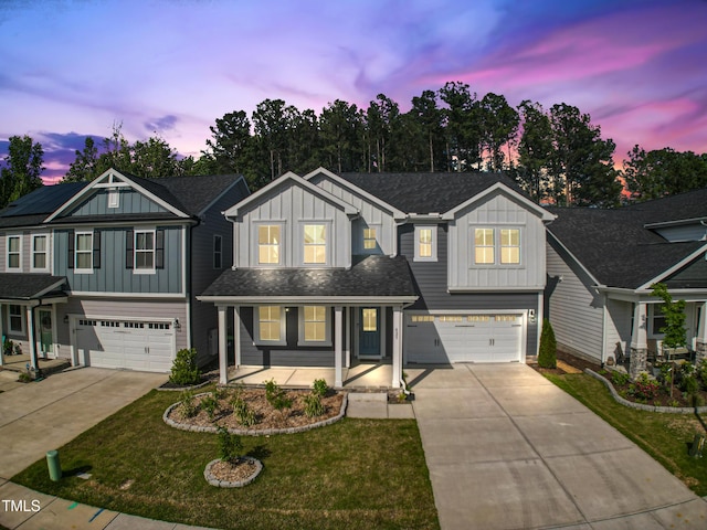 traditional-style house with board and batten siding, an attached garage, and driveway