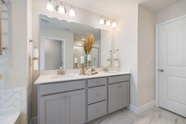 425 Shadow Falls Dr, Wendell, NC 27591 - bathroom featuring double vanity, a tub, marble finish flooring, baseboards, and a shower