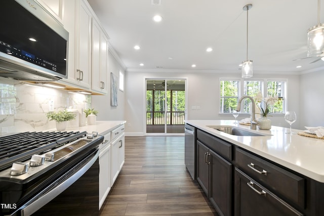 425 Shadow Falls Dr, Wendell, NC 27591 - kitchen featuring appliances with stainless steel finishes, a sink, ornamental molding, light countertops, and white cabinets