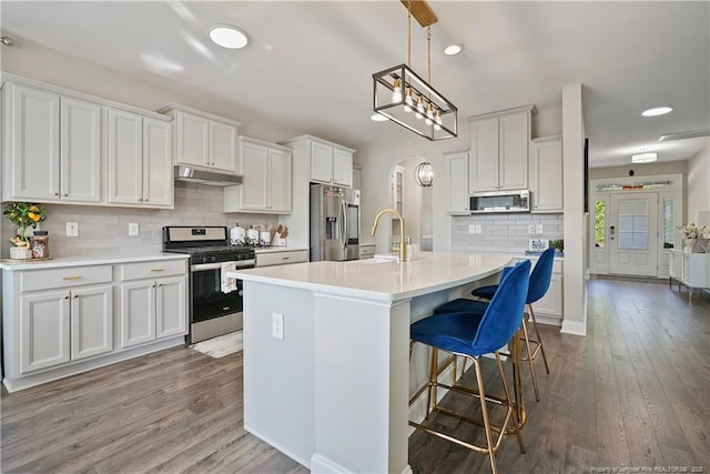 6528 Carswell Dr, Fayetteville, NC 28311 - kitchen with decorative backsplash, a sink, white cabinets, stainless steel appliances, and dark wood-type flooring