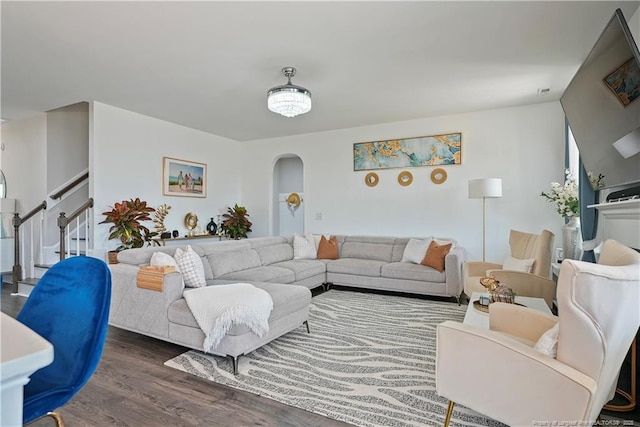 6528 Carswell Dr, Fayetteville, NC 28311 - living area with arched walkways, stairs, and wood finished floors
