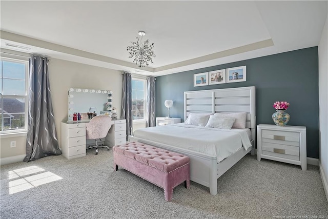 6528 Carswell Dr, Fayetteville, NC 28311 - carpeted bedroom with a tray ceiling, multiple windows, and baseboards
