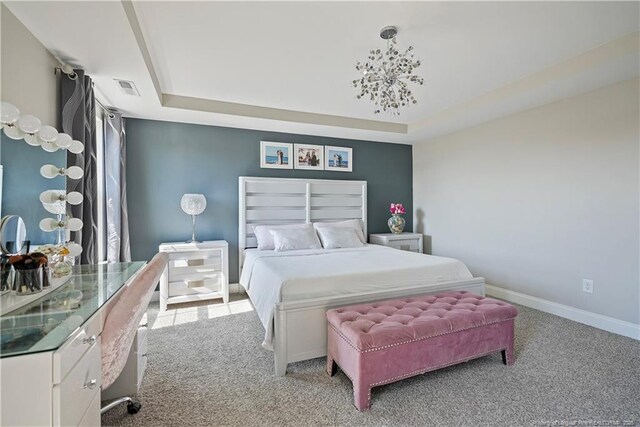 6528 Carswell Dr, Fayetteville, NC 28311 - carpeted bedroom with baseboards, a tray ceiling, and visible vents