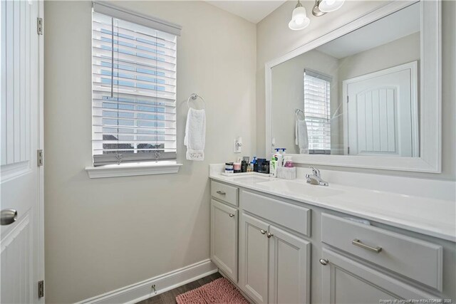 6528 Carswell Dr, Fayetteville, NC 28311 - bathroom featuring baseboards, wood finished floors, and vanity