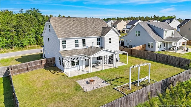 6528 Carswell Dr, Fayetteville, NC 28311 - back of property featuring roof with shingles, a lawn, a patio, an outdoor fire pit, and a pergola