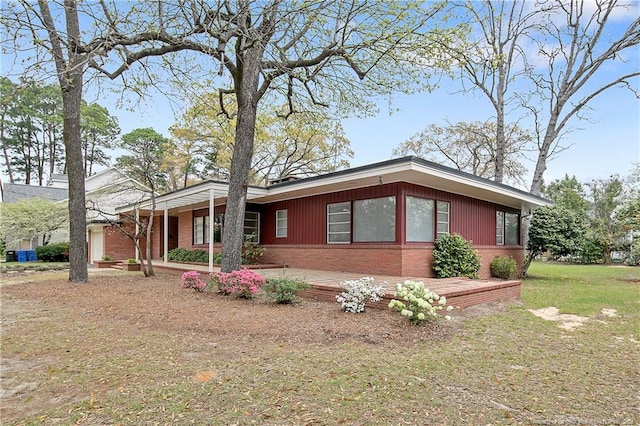 219 Devane St, Fayetteville, NC 28305 - view of front facade featuring a front lawn and brick siding