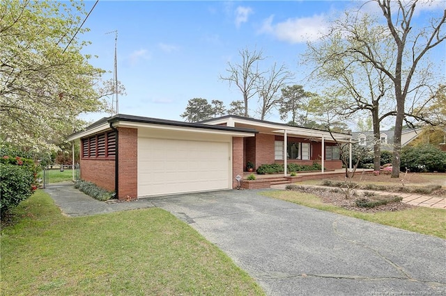 219 Devane St, Fayetteville, NC 28305 - view of front facade with brick siding, driveway, a front yard, and a garage