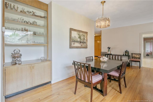 219 Devane St, Fayetteville, NC 28305 - dining room with an inviting chandelier, baseboards, and light wood-type flooring