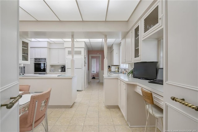 219 Devane St, Fayetteville, NC 28305 - kitchen with a sink, light countertops, white cabinetry, and oven