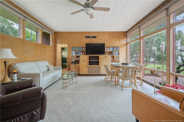 219 Devane St, Fayetteville, NC 28305 - carpeted living room featuring wooden walls, a ceiling fan, and visible vents
