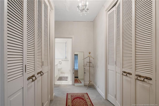 219 Devane St, Fayetteville, NC 28305 - hallway with baseboards, a notable chandelier, and light colored carpet