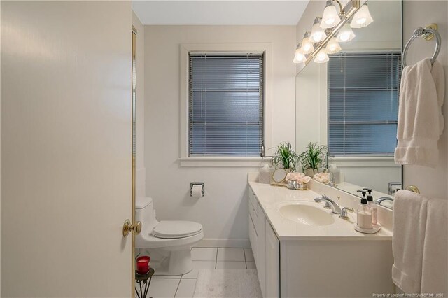 219 Devane St, Fayetteville, NC 28305 - bathroom featuring tile patterned floors, baseboards, vanity, and toilet