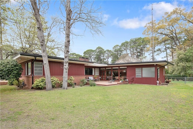 219 Devane St, Fayetteville, NC 28305 - back of property featuring fence, a yard, and brick siding