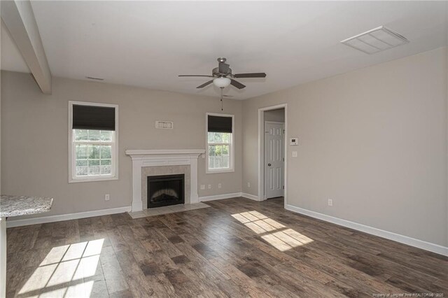 2109 Stonewash Dr, Fayetteville, NC 28306 - unfurnished living room featuring a tiled fireplace, a ceiling fan, baseboards, wood finished floors, and visible vents