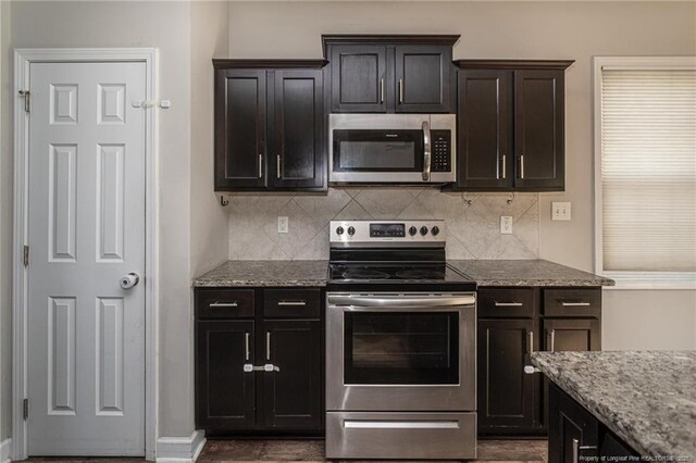 2109 Stonewash Dr, Fayetteville, NC 28306 - kitchen featuring stainless steel appliances, baseboards, light stone counters, and tasteful backsplash