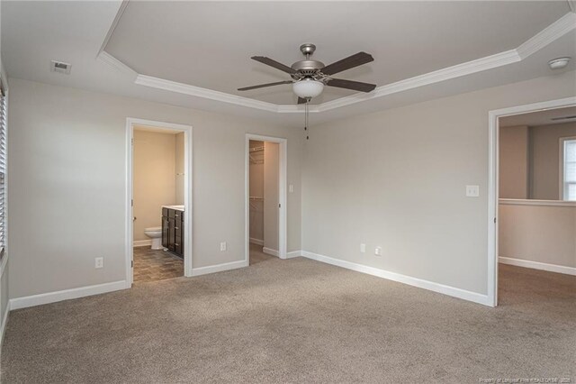 2109 Stonewash Dr, Fayetteville, NC 28306 - unfurnished bedroom with crown molding, a closet, a raised ceiling, a spacious closet, and carpet