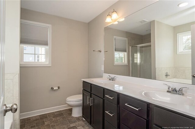 2109 Stonewash Dr, Fayetteville, NC 28306 - bathroom with baseboards, a sink, visible vents, and a shower stall
