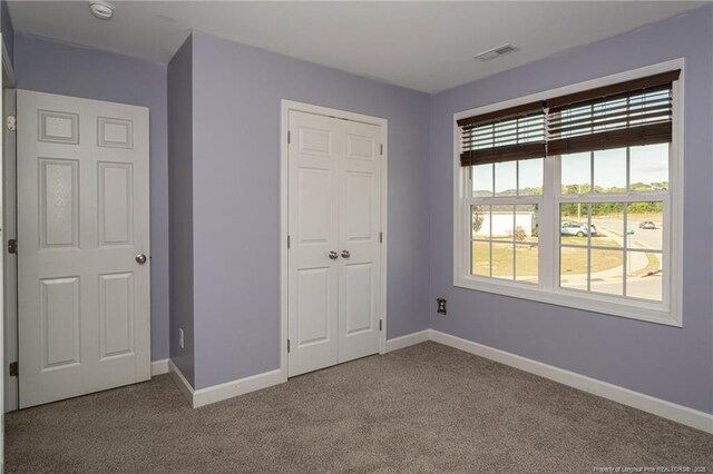 2109 Stonewash Dr, Fayetteville, NC 28306 - unfurnished bedroom with carpet flooring, baseboards, and visible vents