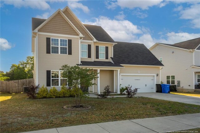 2109 Stonewash Dr, Fayetteville, NC 28306 - view of front of house with fence, an attached garage, driveway, and a front yard