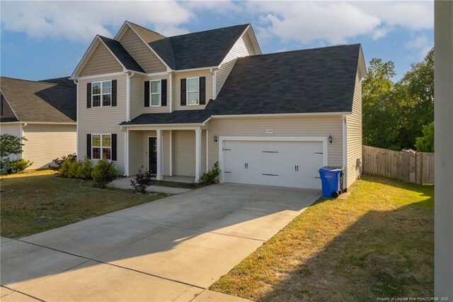 2109 Stonewash Dr, Fayetteville, NC 28306 - view of front of house featuring an attached garage, fence, driveway, and a front yard