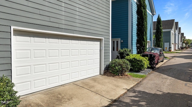 view of side of home with a garage and driveway