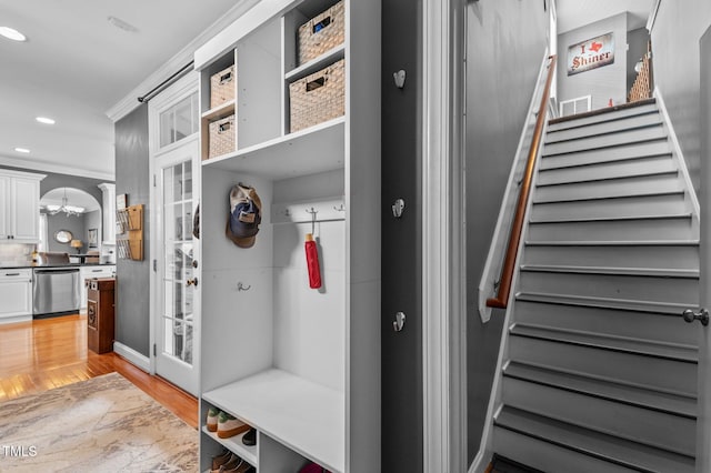 mudroom with a chandelier, light wood-style flooring, recessed lighting, baseboards, and ornamental molding