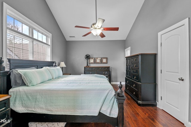 bedroom with a ceiling fan, visible vents, wood finished floors, baseboards, and lofted ceiling