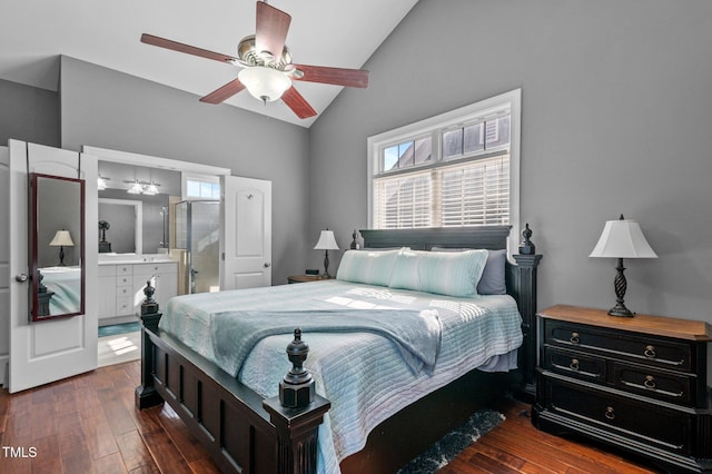 bedroom with ceiling fan, ensuite bath, lofted ceiling, and dark wood-type flooring