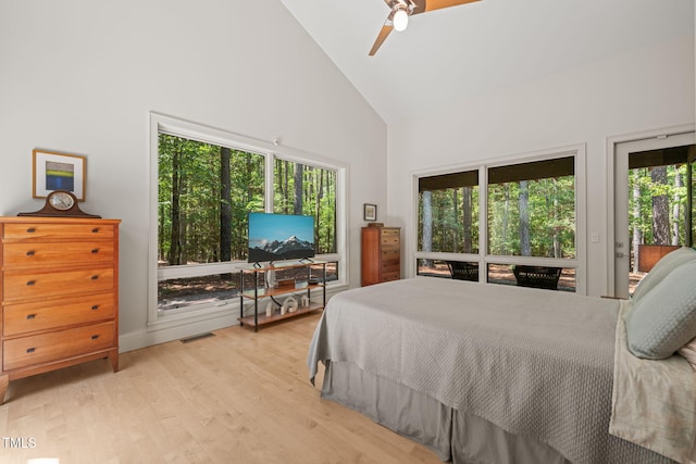 bedroom with high vaulted ceiling, access to exterior, light wood-type flooring, ceiling fan, and baseboards
