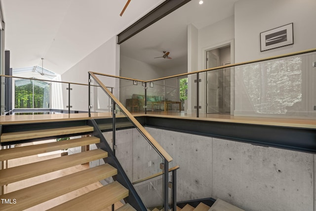 staircase featuring a ceiling fan and lofted ceiling