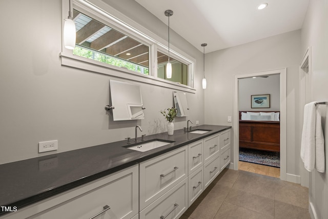 bathroom with double vanity and tile patterned floors