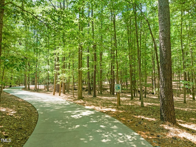 surrounding community featuring a wooded view